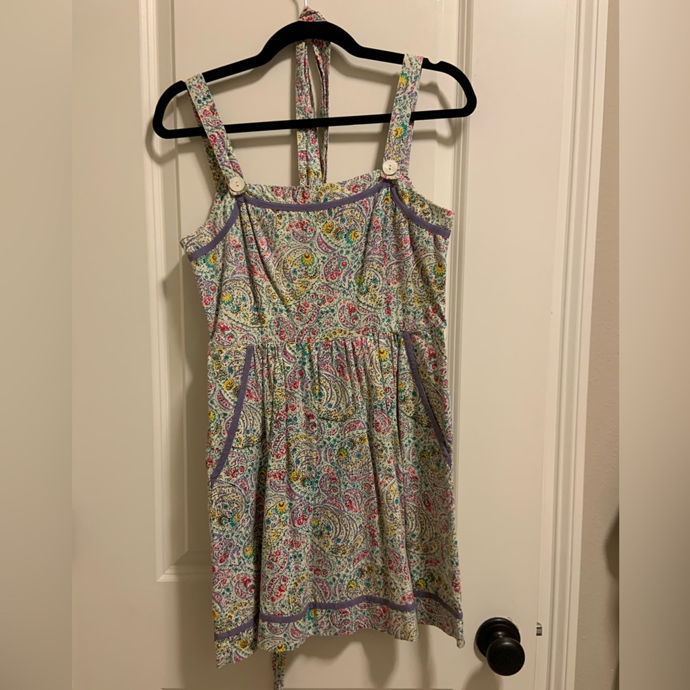 Paisley print dress with belt. Button detail on strap.